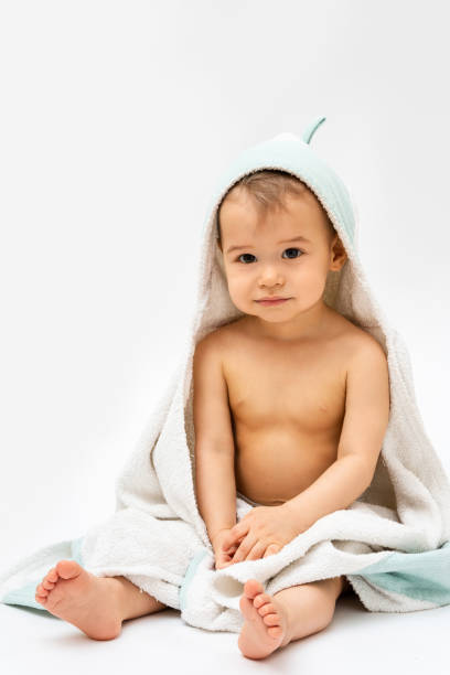 istock Cute baby wrapped into hooded towel after a bathing 1265582062