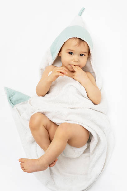 istock Cute baby wrapped into hooded towel after a bathing 1265582119