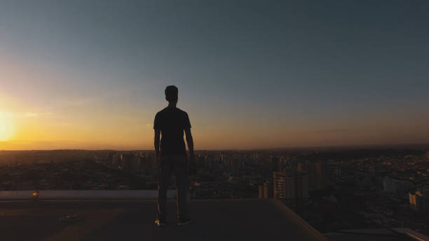 istock Man photographer silhouette at sunset 1265584897