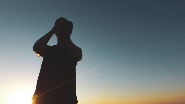 istock Man photographer silhouette at sunset 1265584901