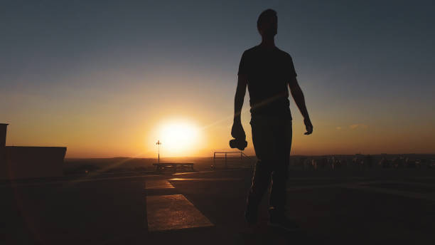 istock Man photographer silhouette at sunset 1265584903