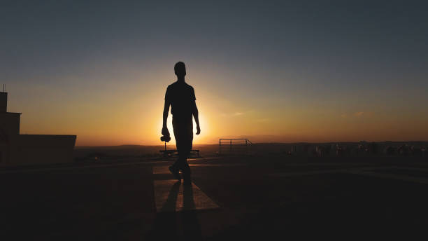 istock Man photographer silhouette at sunset 1265584904
