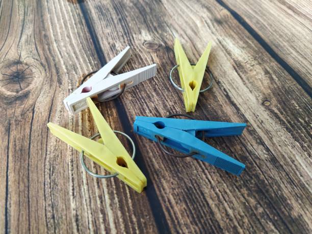 istock Multicolored clothespins on a wooden table 1265587565