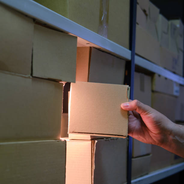 istock Man takes a box from a warehouse at night 1265590616