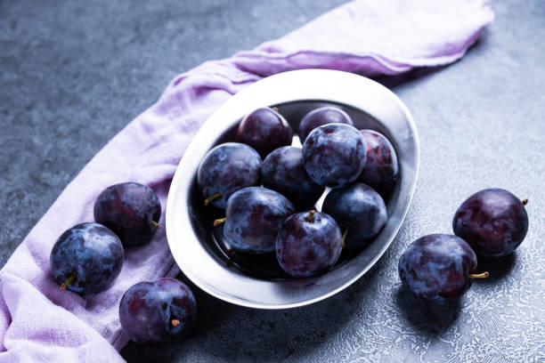 Ripe juicy plums on a Black background stock photo