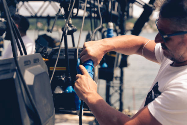 lighting technician installing professional lighting equipment for concert stage , installation with led lights and projectors Arts Culture and Entertainment, Building - Activity, Cable, Concert, Construction Industry sound technician stock pictures, royalty-free photos & images