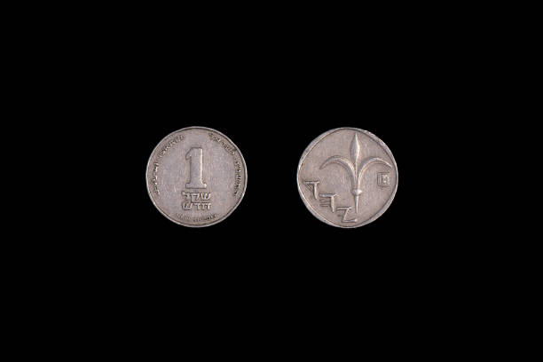 istock One Israeli Shekel from both sides on a black background. Close-up 1265600644