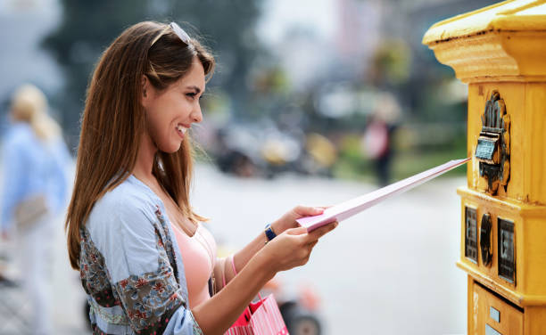 istock Young woman sending a folder and documents via mailbox. Business, lifestyle concept 1265600690