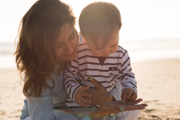 istock Mother at the beach with toddler 1265602880