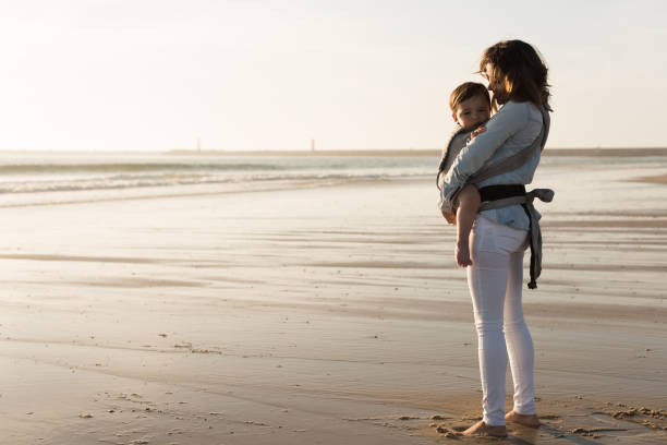 istock Mother carrying baby 1265602947