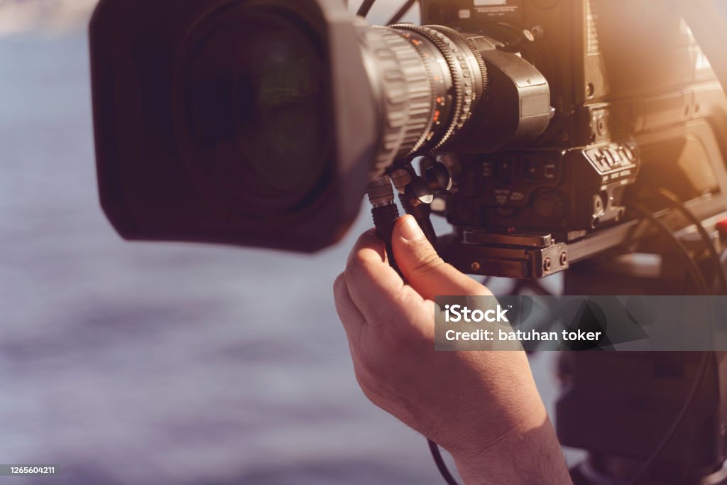 Engineer broadcasting control camera shot live. Blur background USA, Engineer, Movie, Crew, Famous Place Movie Stock Photo