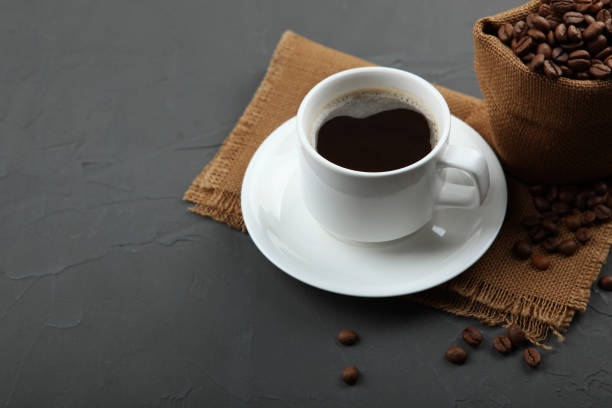 istock coffee beans and coffee cup on colored background with place for text 1265604401