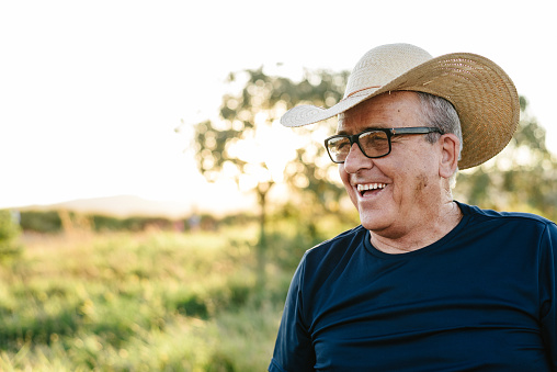 Senior farmer smiling outdoors
