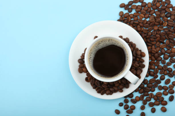 istock coffee beans and coffee cup on colored background with place for text 1265607894