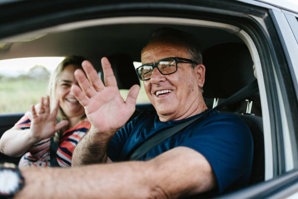 istock Father and daughter waving in the car 1265607969