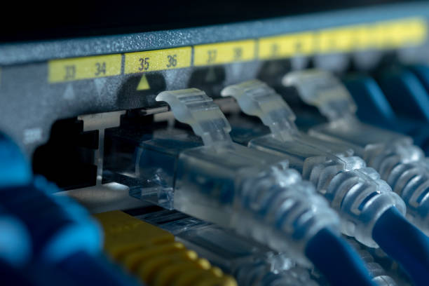 istock Network cable and Gigabit Switch port or LAN UTP cat6 cable in technology data center room. Close up and selective focus. 1265608174