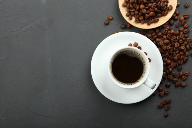 istock coffee beans and coffee cup on colored background with place for text 1265608393