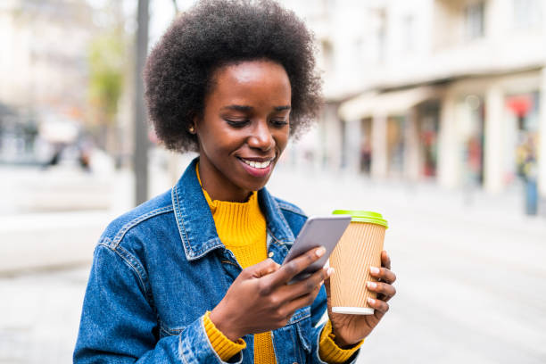 istock Cheerful woman using smart phone in the city. 1265609369