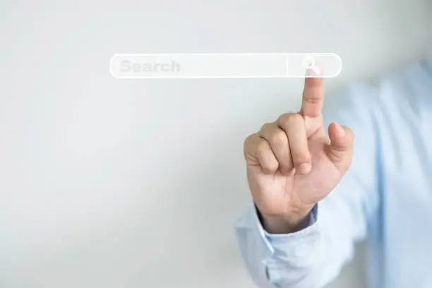 Photo of Searching information network concept with copy space ,  Businessman using hand input keyword and click to virtual internet search page computer touch screen.