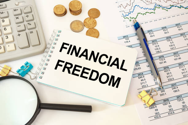Finance Concept - notebook writing Financial FREEDOM stock photo