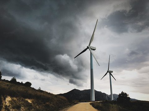 Wind turbines against storm sky, in Navarre (Spain)