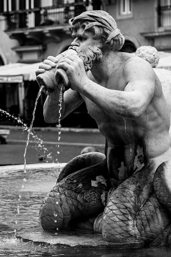 Fontana del Moro, or Moor Fountain, on Piazza Navona, Rome, Italy. Detailed view of sculptures. Black and white image.