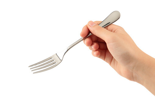 Woman hand holding a fork on white background. Top view