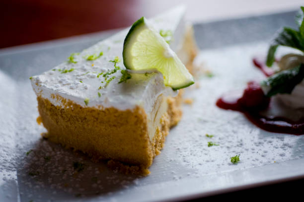istock Key lime pie. Key lime pie with vanilla ice cream. Desserts. Classic American or French bakeries or pastry shop favorites. Cookies, whipped cream, cakes, chocolate syrup butter, eggs and vanilla beans. 1265628126