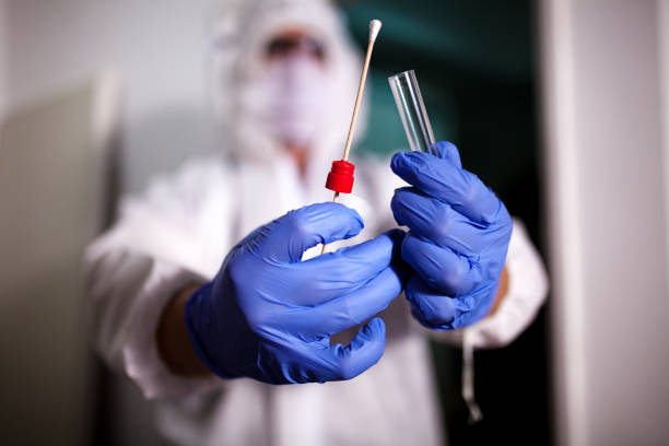 istock Doctor showing covid-19 tube test and sampling swab 1265632911