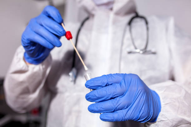 istock Doctor showing covid-19 tube test and sampling swab 1265633011