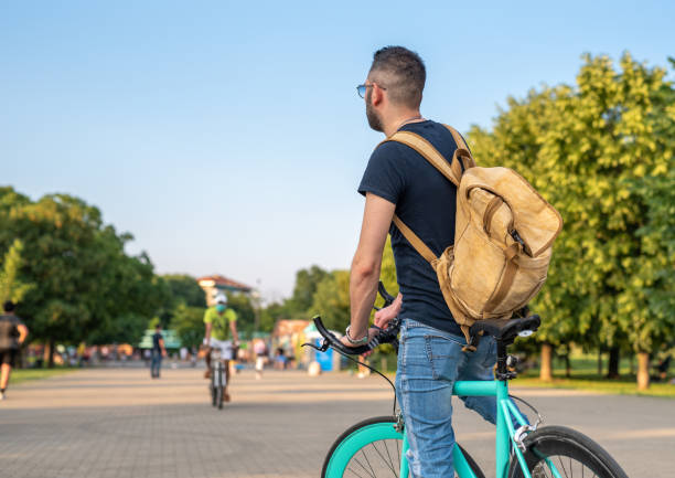 istock young boy seen from behind, standing on his minimalist bicycle, wearing his backpack, concept of urban and ecological mobility in the city and parks 1265636760