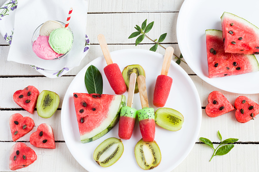 Watermelon kiwi popsicles and ice cream, food knolling theme.