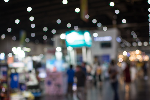 Blurred image of two businessmen walking along corridor