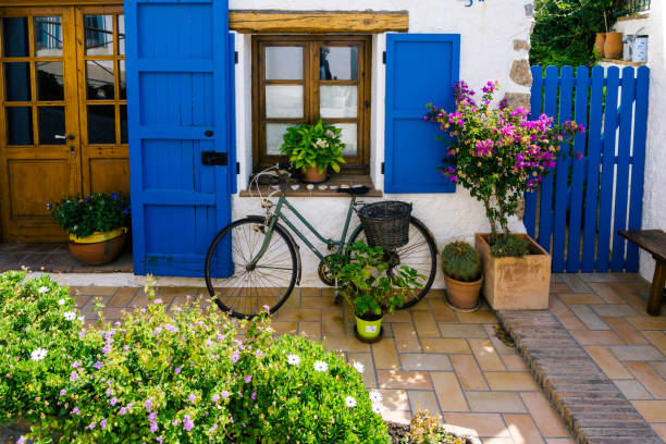 House with bicycle at the door in a Mediterranean village near Barcelona. Montgat House with bicycle at the door in a Mediterranean village near Barcelona. Montgat blue front door stock pictures, royalty-free photos & images