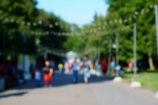 istock Blurred background. A group of people walking in a recreation Park. 1265643802