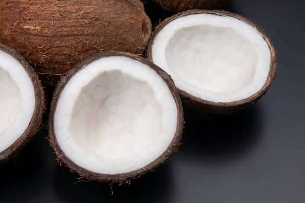 cut fresh coconut on a dark background. vitamin fruits. healthy food