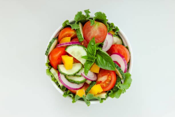 istock Green salad with tomato and fresh vegetables 1265646312