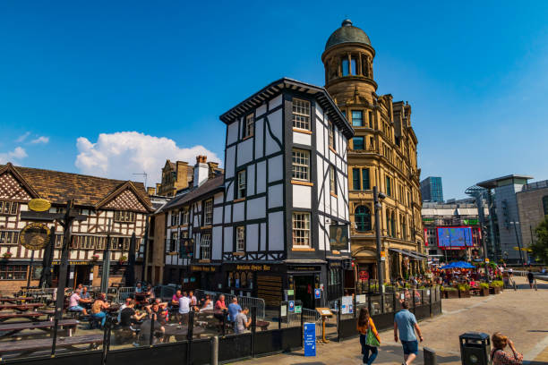 Manchester, United Kingdom - 12 August, 2020 :  People are walking on the Exchange square in Manchester, England