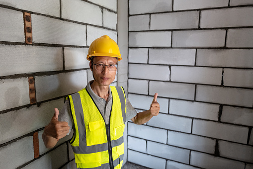 Asian middle-aged male construction worker at construction site