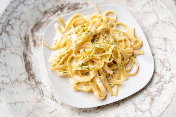 istock Alfredo pasta dinner with creamy white sauce and herbs 1265648882
