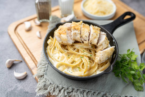istock Chicken Alfredo pasta dinner with creamy white sauce and herbs 1265650405