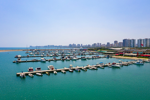 Aerial view of yachts in harbor on the Mediterranean coast. Marina bay with sailboats and yachts