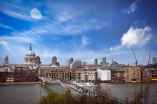 View of the City of London skyline featuring St. Paul’s Cathedral along the side of the River Thames. Aerial view of London’s architecture and scenic river views.