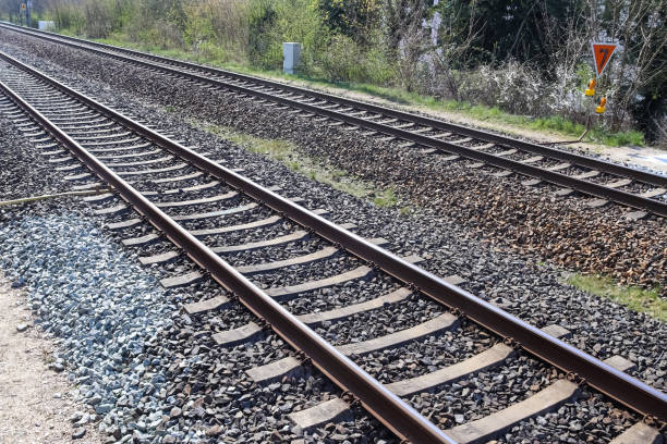 istock Multiple railroad tracks with junctions at a railway station in a perspective and birds view 1265658336