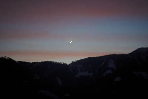 Crescent moon over the mountains