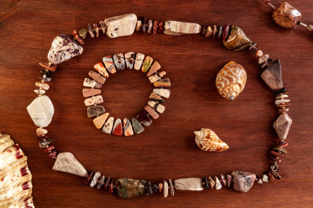 flat Lay with seashells and natural stone bracelet on a wooden background