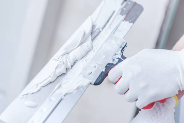 istock Close Up Of Professional Worker Patching Drywall. 1265660384