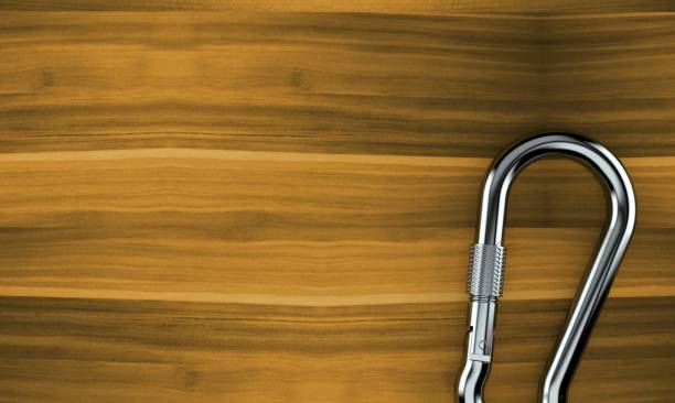 istock Carabiner on wooden background 1265660450