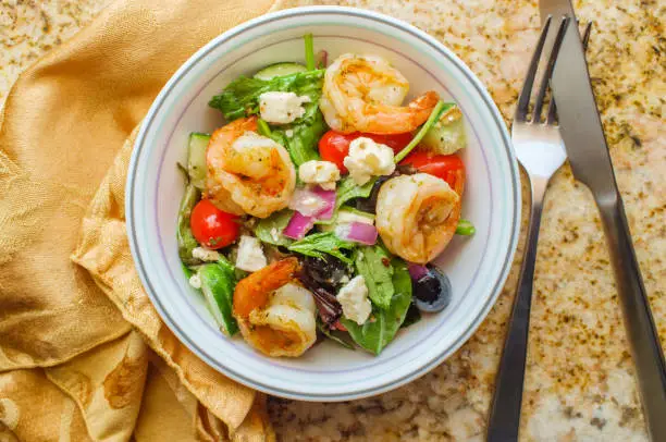 Fresh Greek salad with grilled shrimp and feta cheese with balsamic vinaigrette dressing