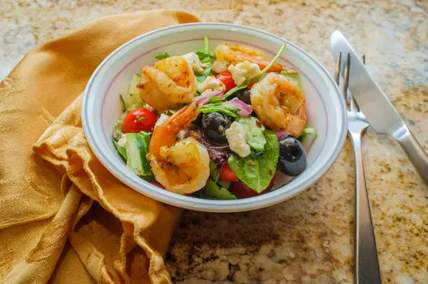 Fresh Greek salad with grilled shrimp and feta cheese with balsamic vinaigrette dressing